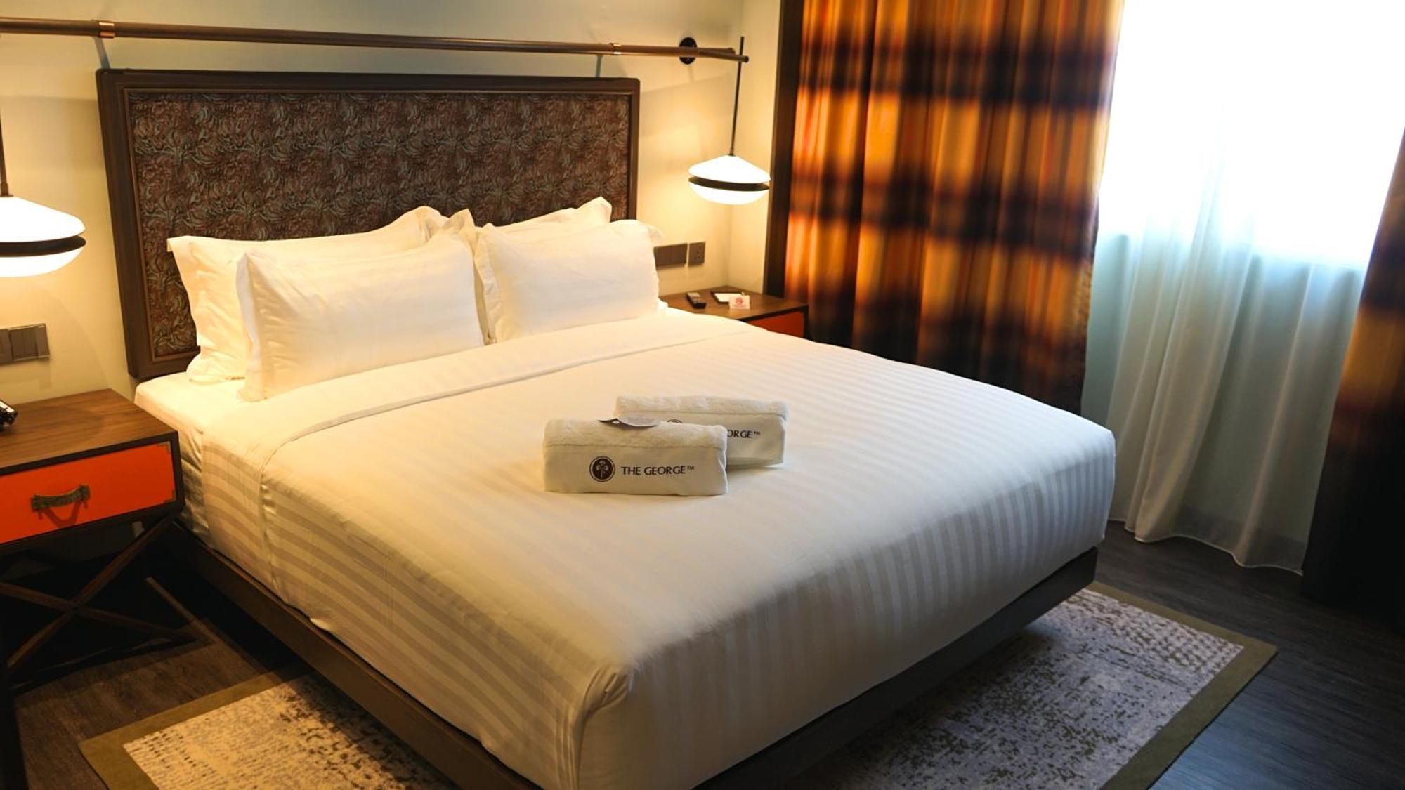 The George Penang By The Crest Collection Hotell George Town Exteriör bild A bed in a hotel room